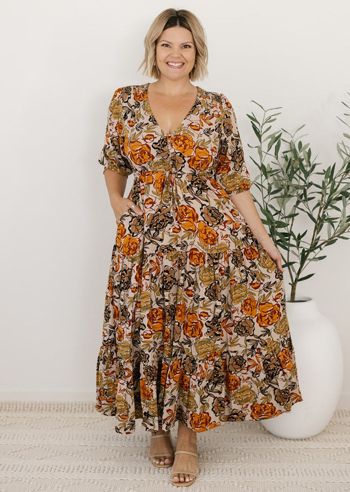 plus-size neutral floral maxi dress with drawstring waist, pockets and long sleeves