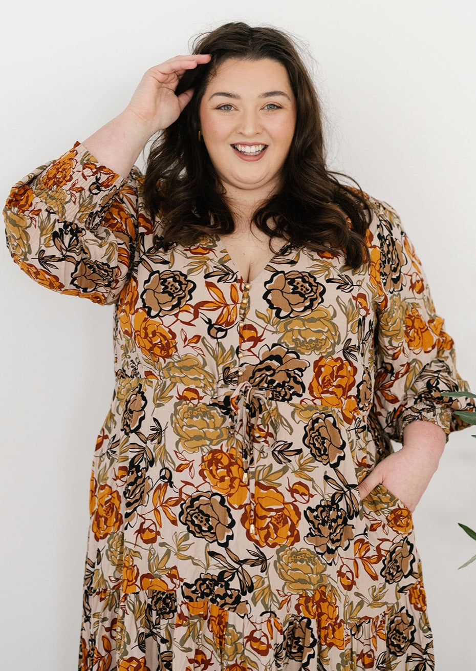 plus-size neutral floral maxi dress with drawstring waist, pockets and long sleeves