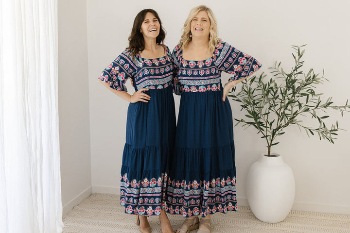 Women’s navy midi dress with floral border and pockets