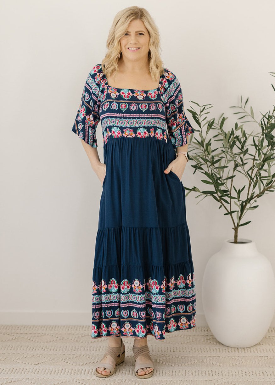 Women’s navy midi dress with floral border and elbow-length sleeves