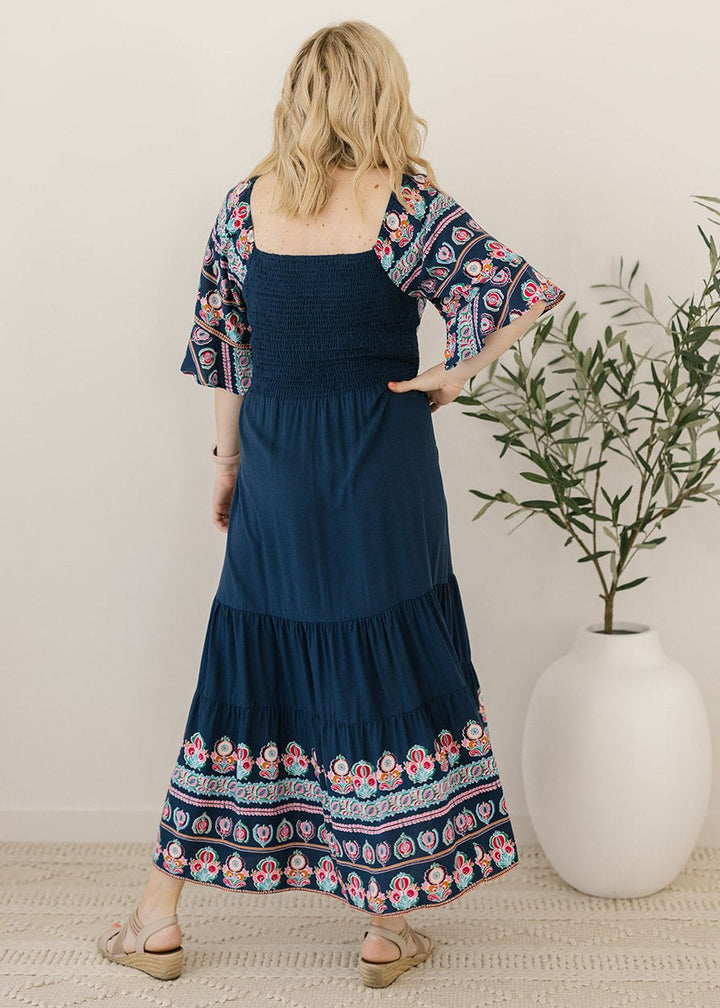 Bump-friendly navy midi dress with floral border